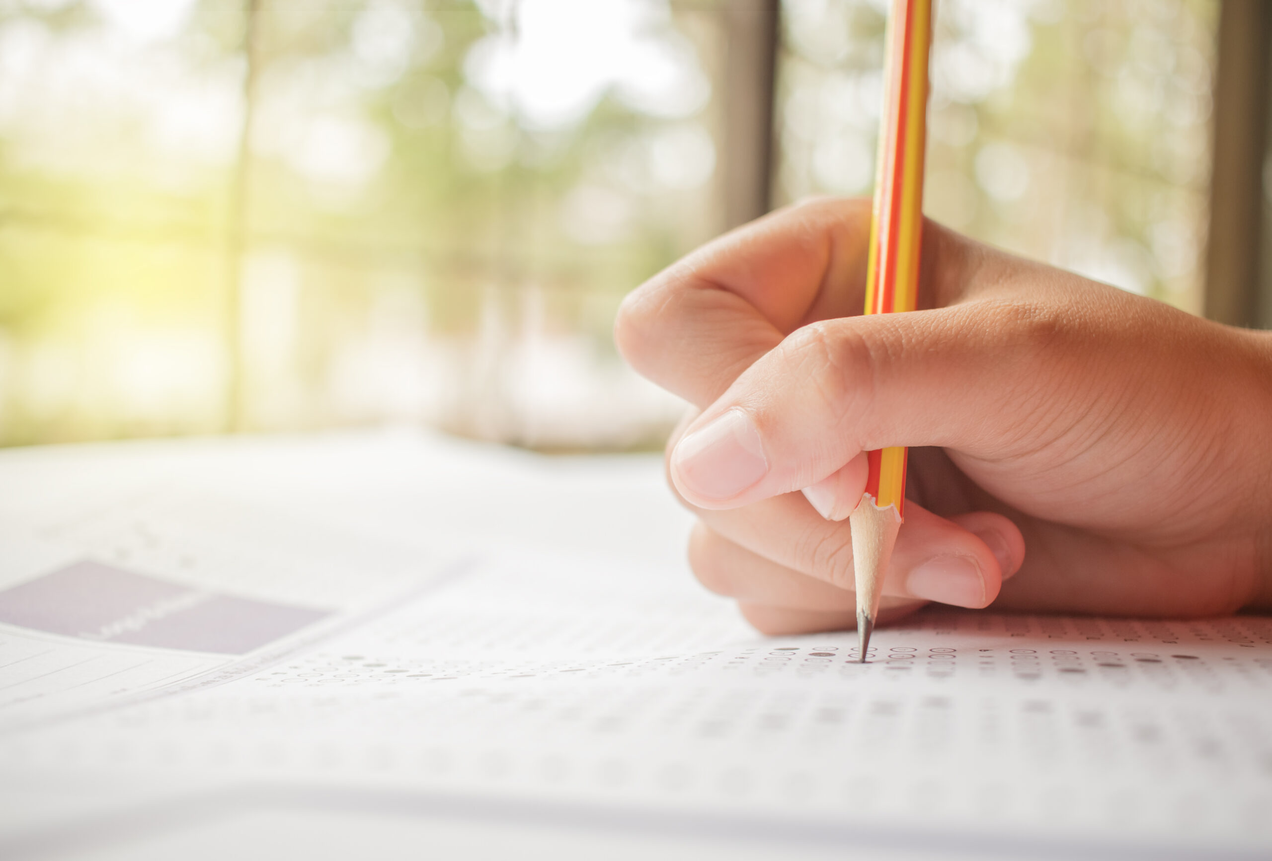 hand student testing in exercise and taking fill in exam carbon paper computer sheet with pencil at school test room, education concept hand student testing in exercise and taking fill in exam carbon paper computer sheet with pencil at school test room, education concept